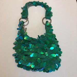 Small mermaid bag with top zipper.